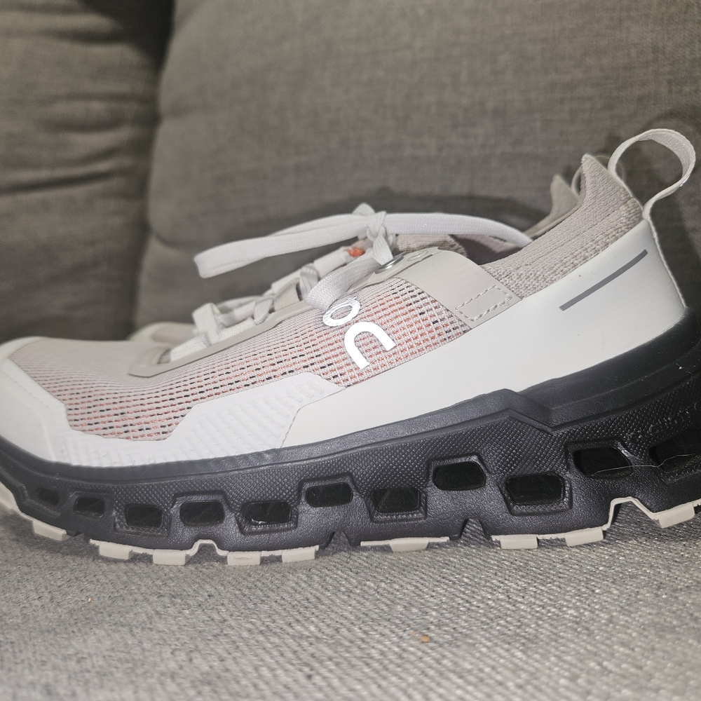 On Running White and Black Athletic Shoes with CloudTec Sole